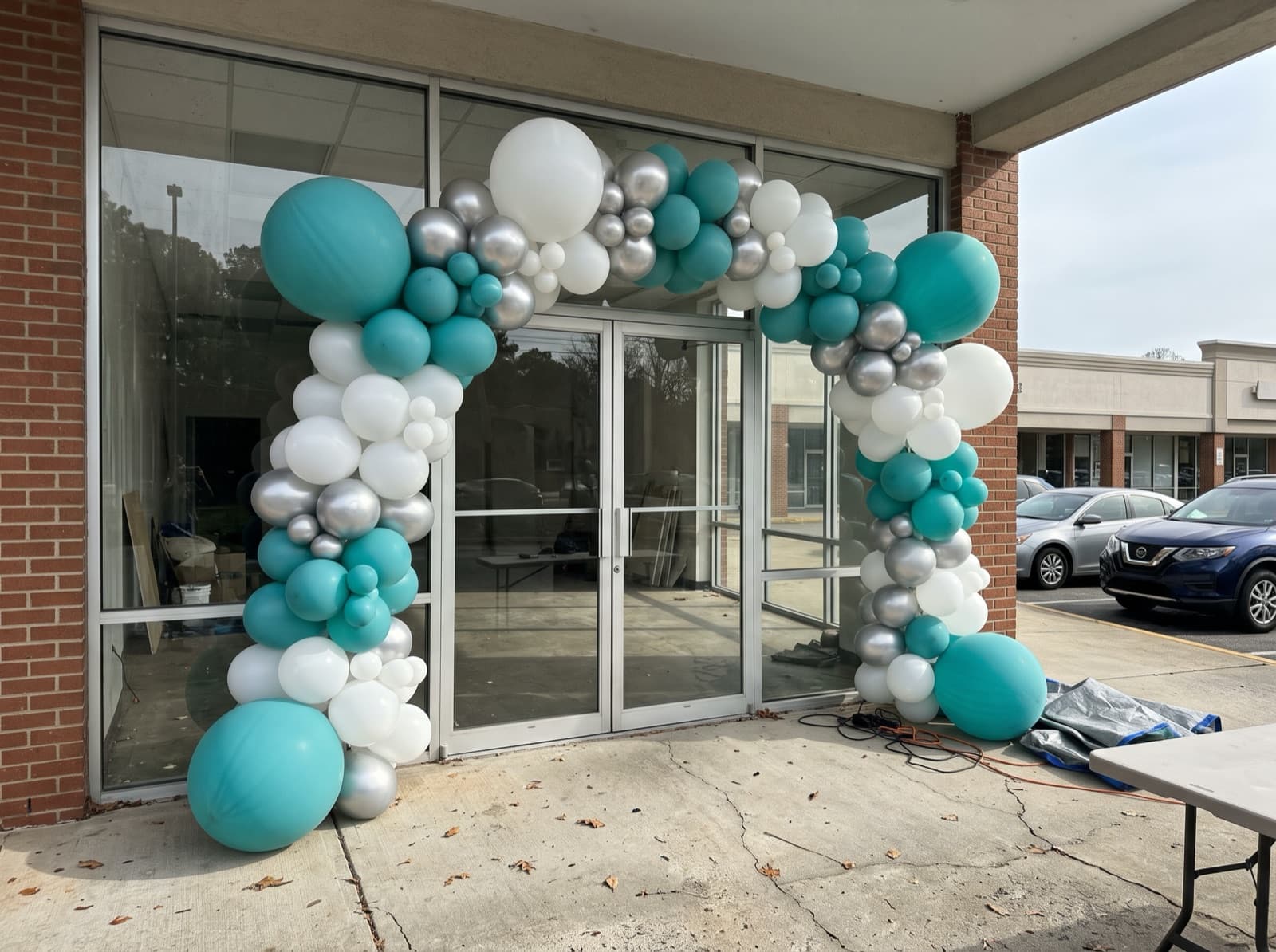 Large balloon arch over a shop entrance